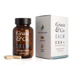 Bottle of CALM CBD capsules for anxiety next to packaging.
